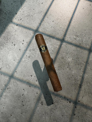 Photo of cigar with black and gold label