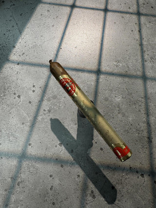 Cigar with a brand logo on a concrete floor