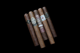Five cigars on a black Background 