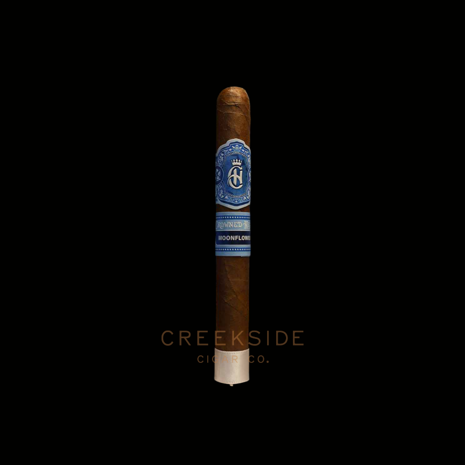 Cigar with a blue label on a black background, featuring the brand 'Creekside Cigar Co.'