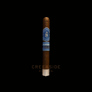 Cigar with a blue label on a black background, featuring the brand 'Creekside Cigar Co.'