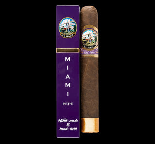 Cigar and purple packaging with 'El Mago' branding on a white background