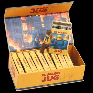 Vintage El Mago Jug cigar packaging and contents displayed on a black background, including an open yellow box with multiple yellow cigars, a tin lighter, and a cigar leaning against the box.