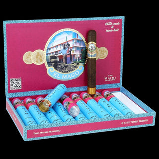 Cigar box with cigars and a decorative plate featuring 'El Mago' branding.