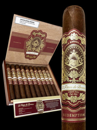 A premium cigar product display featuring an open box of cigars and a single upright cigar. The cigars have dark brown bodies with gold and burgundy labels.