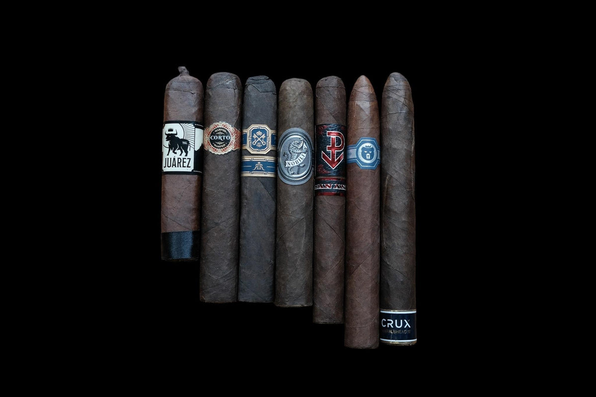 Assorted cigars with visible branding on a black background
