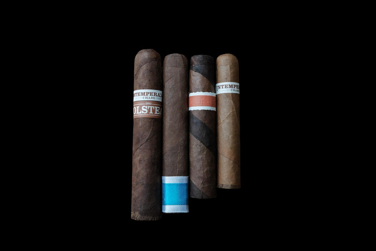 Four Cigars on a black background 