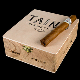 Cigar box with a cigar on top, featuring 'Tain' branding.