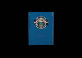 A blue hardcover book titled 'The Azorian' with an ornate crest emblem on the front, centered against a solid black background.