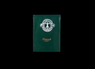 A dark green hardcover book or notebook with a silver circular emblem and the word 'Tradecraft' printed near the bottom, centered on a solid black background.