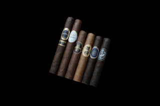 Five cigars with visible labels on a black background